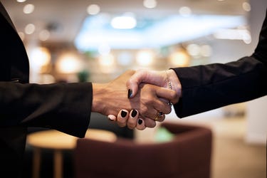 handslag tva kvinnor